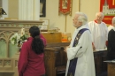 A mother lights the Paschal candle on Mothering Sunday
